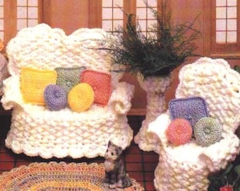 May include: A white crocheted dollhouse sofa and armchair with colorful pillows and a small crocheted rug.