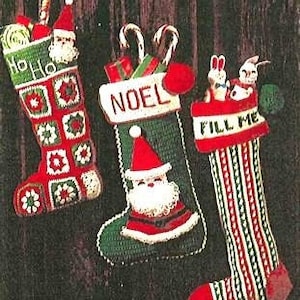 May include: Three crocheted Christmas stockings with different designs. The first stocking is green and red with a white square pattern and the text "Ho Ho Ho". The second stocking is green with a white "NOEL" design and a Santa Claus face. The third stocking is red and white with a green stripe pattern and the text "Fill Me".