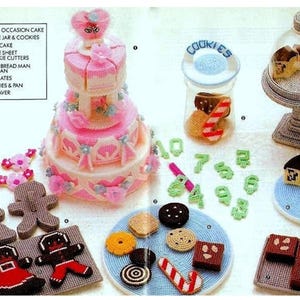 May include: A set of plastic canvas craft patterns for making various cake-themed items, including a wedding cake, a cookie jar, a gingerbread man and woman, and a plate of brownies. The patterns are printed on white paper with black text and include instructions for making each item.