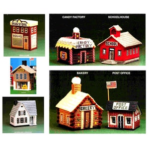 May include: A collection of eight miniature plastic canvas houses, each representing a different type of building, including a drug store, candy factory, schoolhouse, depot, bakery, and post office. The houses are all decorated with colorful details and have a whimsical, vintage aesthetic.