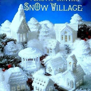 May include: A plastic canvas craft kit for making a snow village. The kit includes patterns for several white houses, trees, and other wintery details. The kit is titled "Plastic Canvas Snow Village".