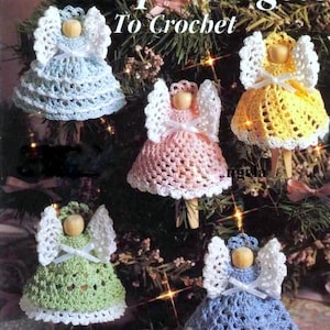 May include: Five crocheted angel ornaments hanging on a Christmas tree. The angels are made in different colors, including blue, pink, yellow, green, and white. Each angel has a white crocheted halo and a white ribbon around its waist.