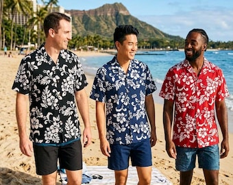 May include: Three men wearing Hawaiian shirts with floral patterns, walking on a sandy beach. The shirts are black, navy blue, and red, each with white floral designs. They are paired with black and navy blue shorts. The background includes the ocean, a mountain, and palm trees.