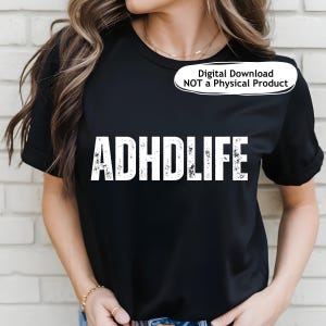 May include: Black t-shirt with the white text "ADHDLIFE" in a distressed font. The shirt is a digital download, not a physical product. The model is wearing a gold necklace and bracelet.