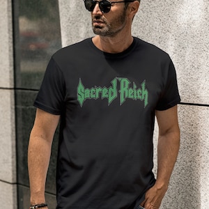May include: A black t-shirt with a green graphic of the band "Sacred Reich" printed on the front.