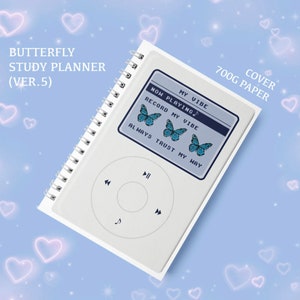 May include: A white spiral bound notebook with a blue and white iPod design. The notebook has the text "My Vibe" and "Now Playing" on the front cover. The notebook also has the text "Record My Vibe" and "Always Trust My Way" on the front cover. The notebook has a 700g paper cover.