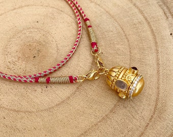 Talismano indiano protettivo e purificante, amuleto a campana placcato in oro 24k con quarzo fumé e pietre preziose di granato, cristalli di zirconio su Dori indiano