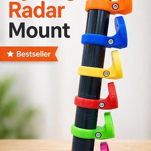 Peut inclure: Support de radar de vélo multicolore, disponible en orange, bleu, jaune, rouge, vert et rose. Le texte "Cycling Radar Mount" est affiché en orange et noir. Le texte "Bestseller" est sur une bannière.