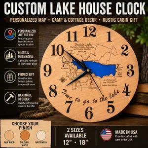 May include: A round wooden wall clock featuring a map of Oneida Lake in New York with a blue water inlay. The clock face displays black numbers from 1 to 12, a compass rose, and the text Time to go to the lake. It includes black clock hands.