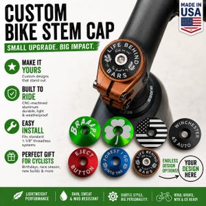May include: A custom bike stem cap installed on a bicycle handlebar stem, accompanied by several circular aluminum caps in various colors including green, red, blue, and black, featuring engraved designs like a clover, flag, and text.