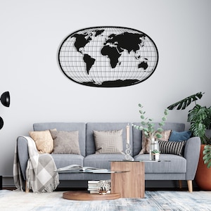 Puede incluir: Un mapa del mundo de metal negro, de forma ovalada, con un patrón de cuadrícula. Cuelga de una pared blanca sobre un sofá gris con cojines. También se ven una lámpara de pie moderna y una planta en maceta.