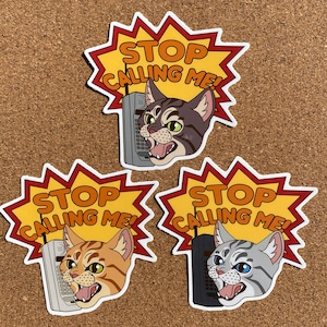 May include: Three yellow and orange stickers with a cartoon cat and a phone. The text on the stickers says "Stop Calling Me!"