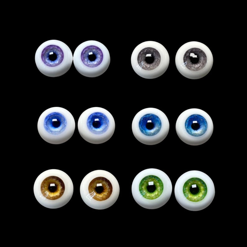 May include: Set of ten doll eyes in various colors, including blue, green, brown, and gray. The eyes are made of glass and have a realistic appearance.