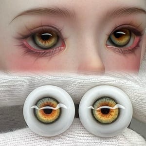 May include: Two pairs of realistic doll eyes with a green iris and a brown pupil. The eyes are on a white surface.