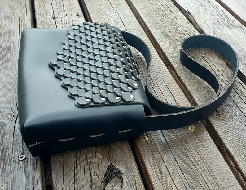 Black leather handbag with flakes