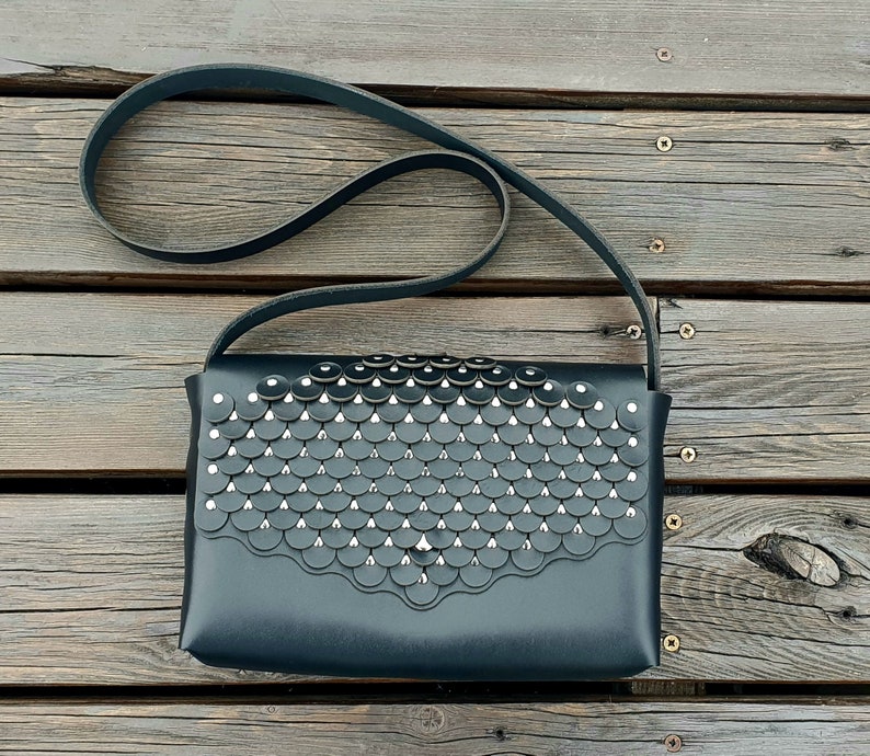 Black leather handbag with flakes