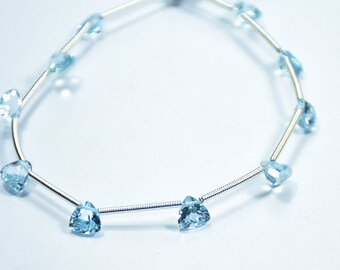 May include: A silver chain necklace with light blue triangular gemstones.