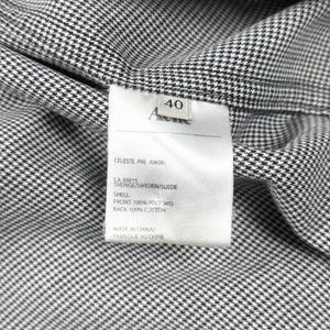 May include: A black and white houndstooth patterned garment with an interior white fabric care label. The label displays the text Acne, size 40, CELESTE PRE AW09, CA 39815, SVERIGE/SWEDEN/SUEDE, SHELL: FRONT: 100% POLYAMID, BACK: 100% COTTON, MADE IN CHINA.