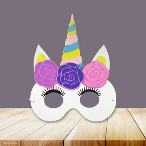 May include: White unicorn mask with a pink, blue, and yellow spiral horn and three pink, purple, and light pink flowers. The mask has eye holes and a black elastic band.