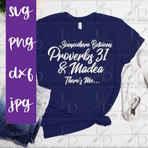 May include: A navy blue t-shirt with white text that reads "Somewhere Between Proverbs 31 & Madea There's Me..."