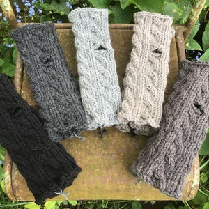 Cuffs made of 100% wool with a cable pattern and thumb hole