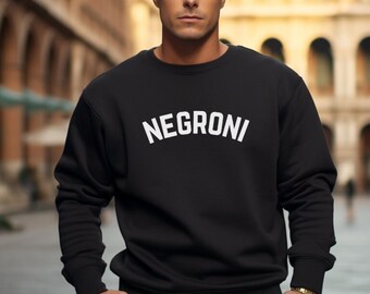 May include: Black sweatshirt with white text that reads "NEGRONI" in an arched font.