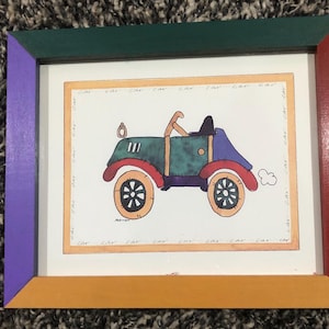 May include: A framed illustration of a cartoon car with a green body, red wheels, and a blue top. The car has a white cloud behind it and the words "car" are written around the border of the image.