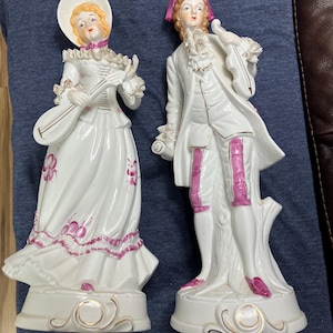 Vtg Victorian porcelain mucical couple  dressed in white and burgundy.