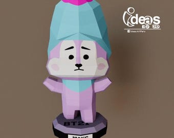 May include: A purple and blue papercraft figurine of a cartoon character with a pink hat. The character has a white face with black eyes and a black nose. The base of the figurine is black and has the text "BT21" and "MANG" on it.