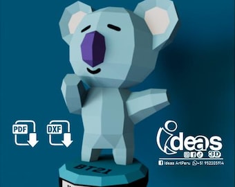 May include: A blue and white 3D papercraft model of Koya, a character from the K-pop group BTS. The model is standing on a base with the text "BT21" and "KOYA" printed on it.