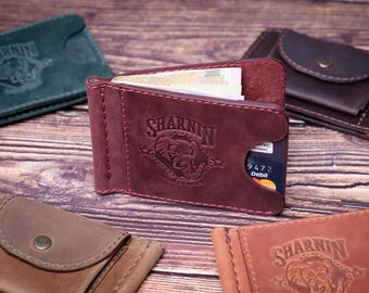 May include: A set of four leather wallets in different colours. The wallets feature a money clip, a card slot, and a small pocket. The wallets are embossed with the logo "SHARNNIN" and the text "Leather Goods".