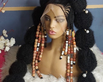 May include: A black wig with braided hair styled in two high buns with beaded strands hanging down. The wig is on a mannequin head with a white fur collar.