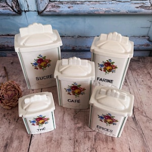 May include: A set of three ceramic mugs with a speckled, matte finish. The mugs are in shades of cream, light grey, and dark grey. Each mug has a simple, minimalist design, ideal for coffee or tea.