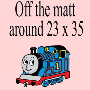 Puede incluir: Ilustración de un tren azul con el número 1 en un lateral, sobre un fondo rosa claro. El texto "Off the matt around 23 x 35" se muestra encima del tren. El tren tiene una cara sonriente.