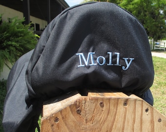 May include: Black saddle cover with blue embroidery that reads "Molly".