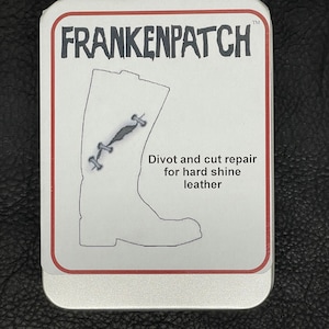 May include: A rectangular metal tin with the text "FRANKENPATCH" in black, with a red border. The tin features an illustration of a boot with a stitched repair, and the text "Divot and cut repair for hard shine leather."