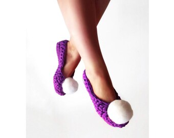 May include: Purple crocheted slippers with white pom-poms.