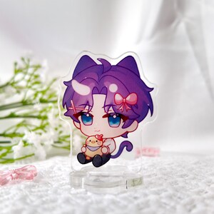 May include: A purple and white anime character with cat ears and a pink bow holding a yellow chick. The character is standing on a clear acrylic stand.