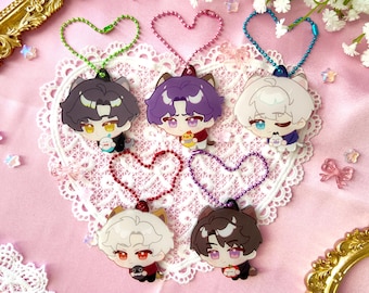 May include: Five colorful character charms with heart-shaped keychains. Each charm features a different anime-style character with a cat-like design. The charms are made of clear acrylic and have a glossy finish.