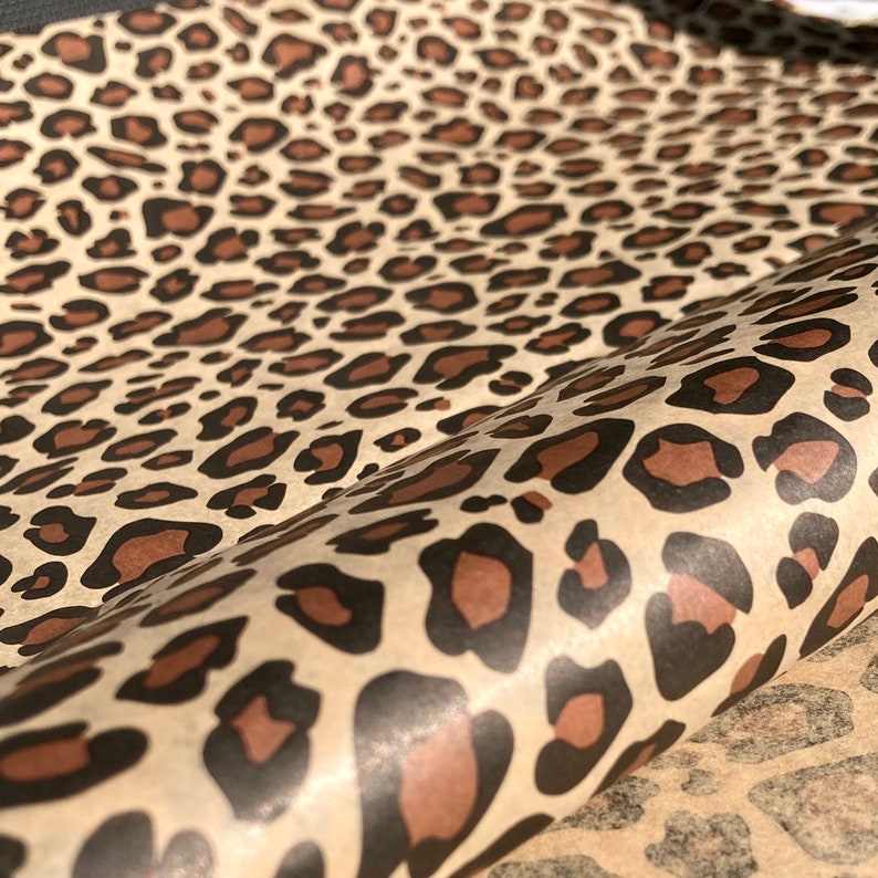 May include: Brown and black leopard print wrapping paper. The paper has a subtle sheen and is ideal for gift wrapping.