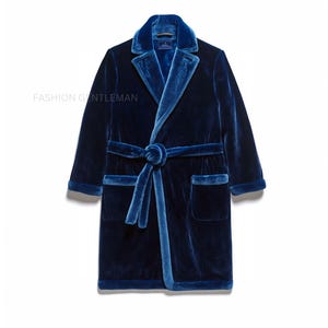 May include: A blue velvet robe with a self-tie belt and a faux fur lining. The robe has a shawl collar and two patch pockets.
