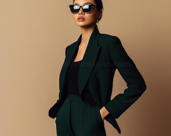 May include: A woman wearing a dark green blazer and matching pants. She is wearing a black top and black sunglasses.