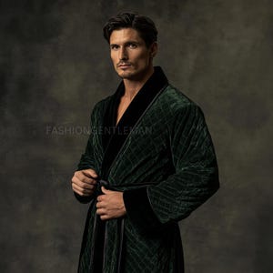 May include: A dark green velvet robe with a quilted design and black trim. The robe is secured at the waist with a matching belt. The text "FASHIONGENTLEMAN" is visible. This luxurious robe is a stylish garment for lounging or after a bath.
