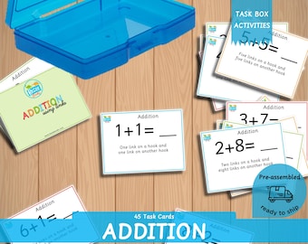 May include: A set of 45 task cards for teaching addition using links. The cards are colorful and feature a variety of addition problems. The cards are pre-assembled and ready to ship. The cards are in a blue plastic container.