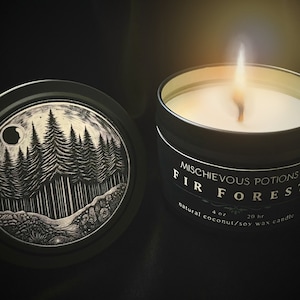 May include: A black candle tin with a white label that reads "Mischievous Potions Fir Forest 4 oz 20 hr natural coconut/soy wax candle". The lid of the tin features a black and white illustration of a forest with a crescent moon.