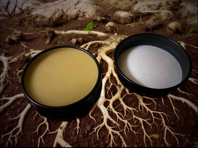 Open tin of Earth solid natural perfume on soil with roots. The fragrance combines earthy, smoky, & herbaceous elements with botanical musk, resinous warmth, & refreshing herbal notes. Ideal for nature lovers seeking a bold, lasting scent