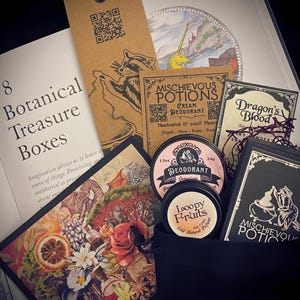 A meticulously crafted gift set with Mischievous Potions products. Packaged in a black velvet pouch with original botanical art, includes natural deodorant, Dragon’s Blood perfume, and solid perfume, ideal for witchy and nature-inspired gift-giving.