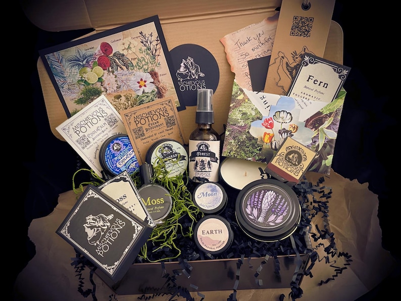 Beautifully curated gift box featuring Mischievous Potions products, natural deodorant, perfumes, candles, & original art. Ideal for lovers of handcrafted, eco-friendly self-care items. Whimsical gift for nature enthusiasts & magical apothecary fans