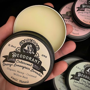 May include: Three open containers of natural deodorant with different scents. The scents are Cedarwood Orange Lemongrass Lavender, Geranium Ylang Ylang Pink Grapefruit, and Clary Sage Palo Santo Cypress Pine. Each container is 68 grams and 100% natural.