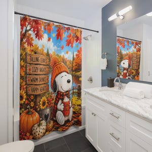 May include: A shower curtain featuring a cartoon dog wearing an orange knit hat and scarf, holding a red mug labelled HELLO FALL. The scene includes a wooden sign with the text FALLING LEAVES, COZY NIGHTS, WARM DRINKS, HAPPY HEARTS, pumpkins, and sunflowers.